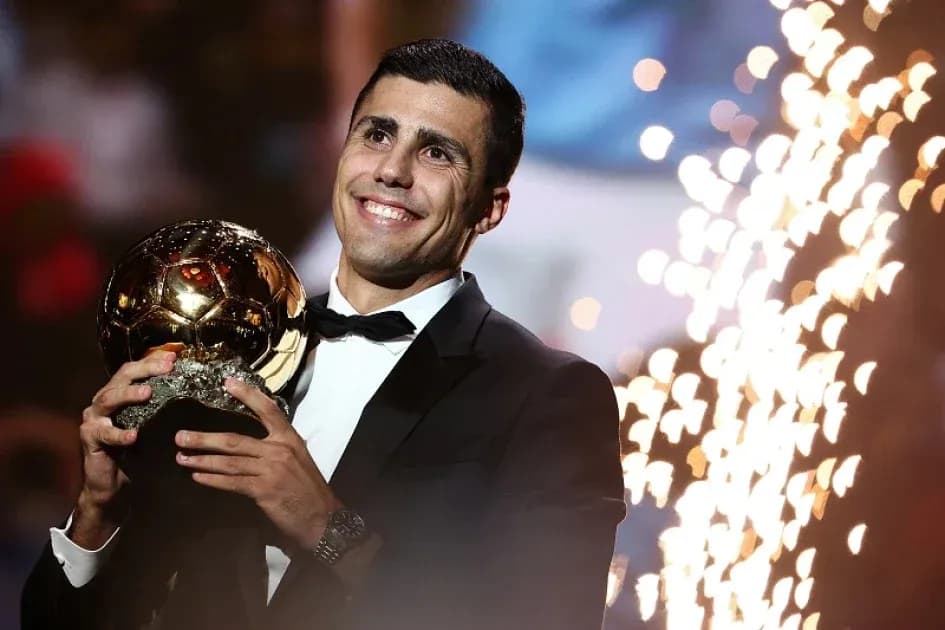 Player holding Ballon d'Or trophy at ceremony