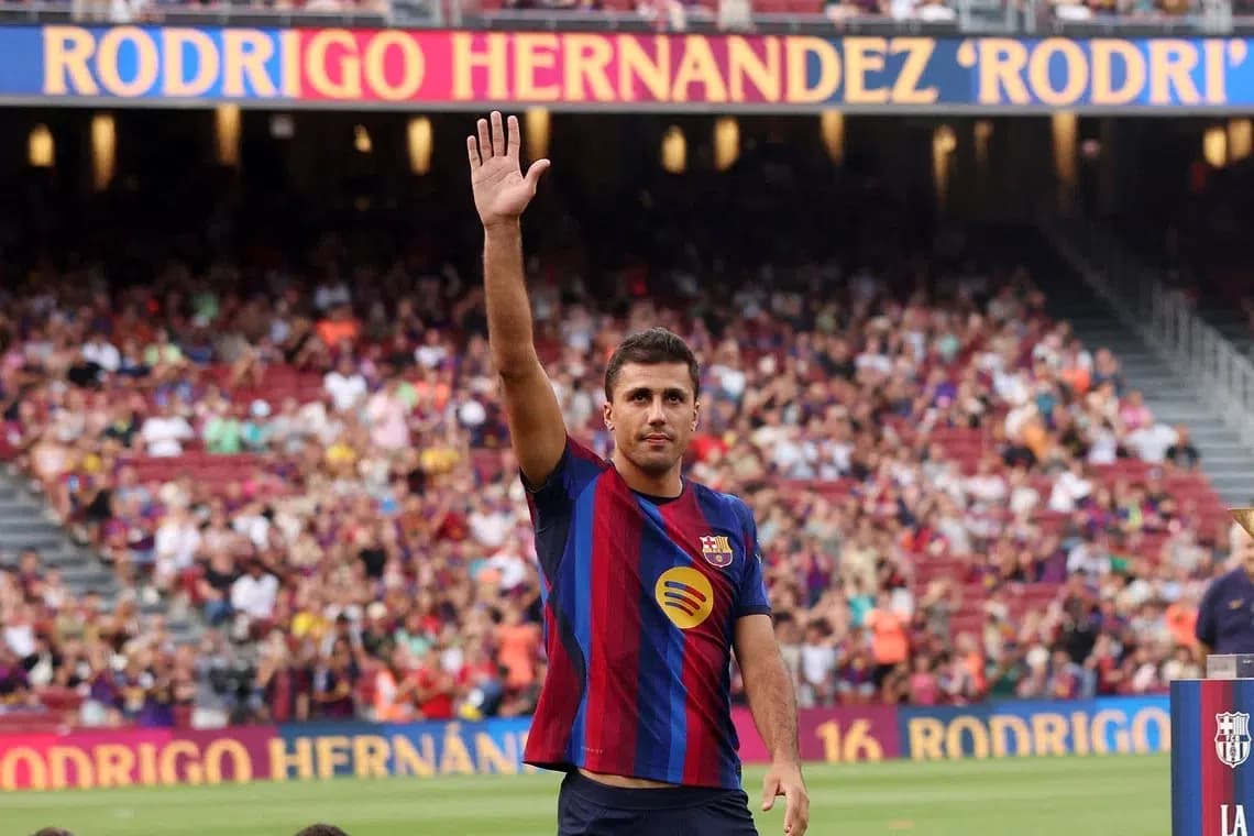Player waving to crowd at stadium event