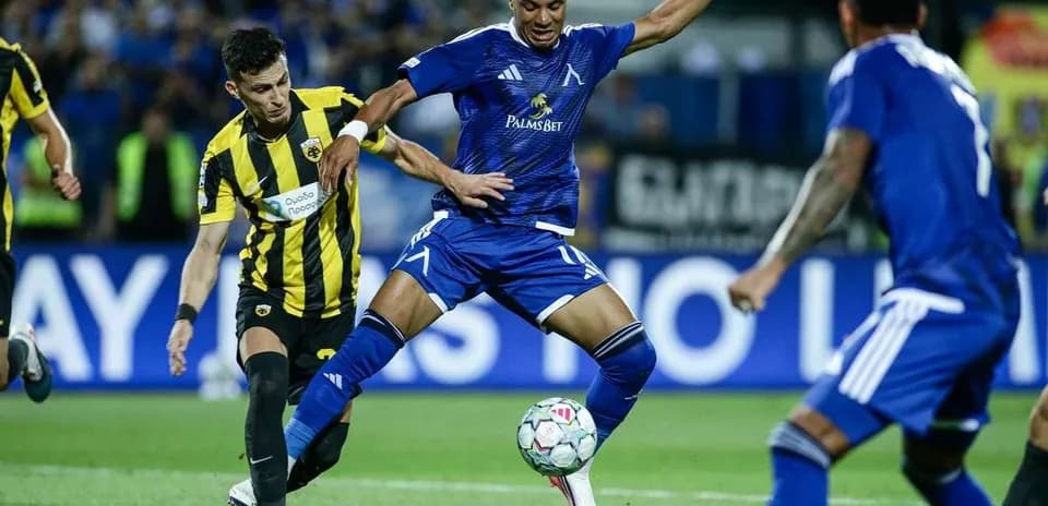 Levski Sofia player dribbling past AEK Athens defender