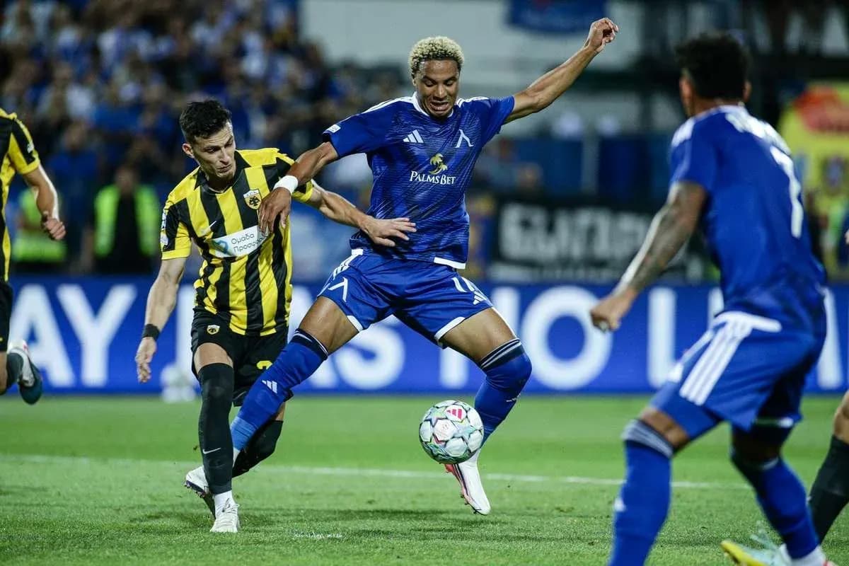 Levski Sofia player dribbling past AEK Athens defender