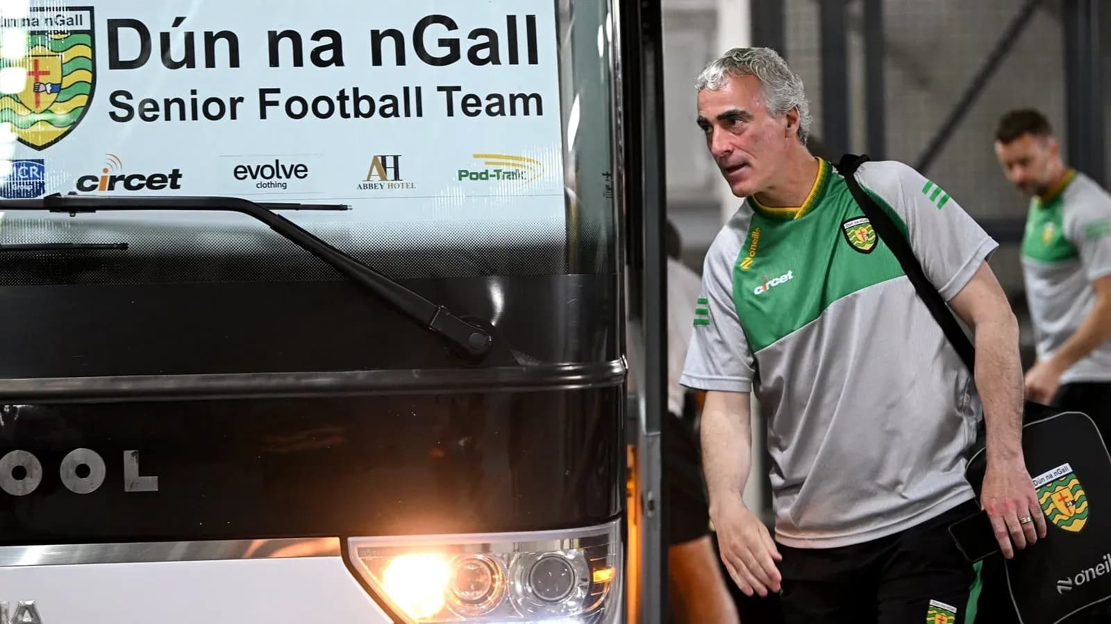 Manager exiting team bus before match