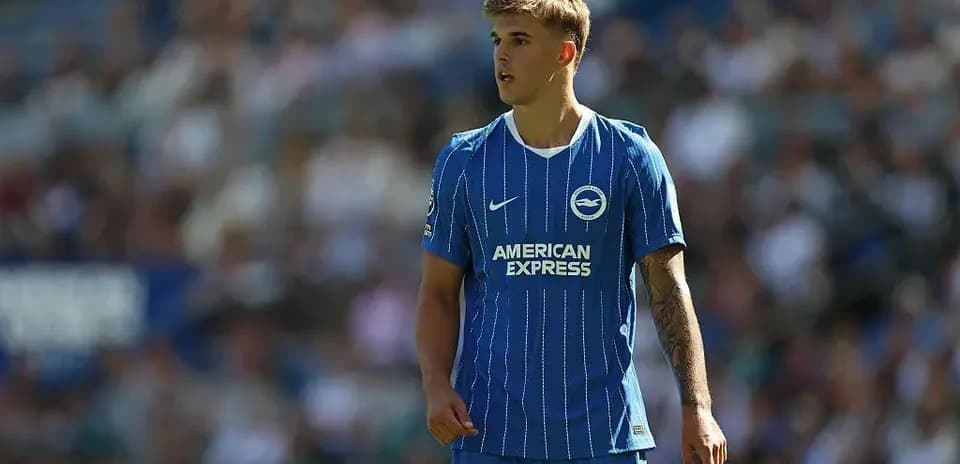 Player in blue kit during match at stadium