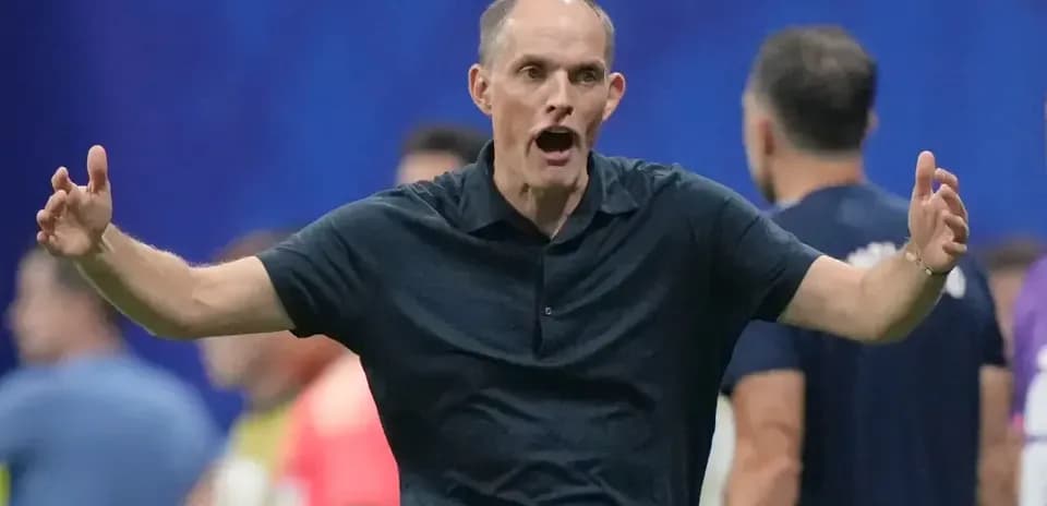 Coach gesturing passionately on the sidelines during match