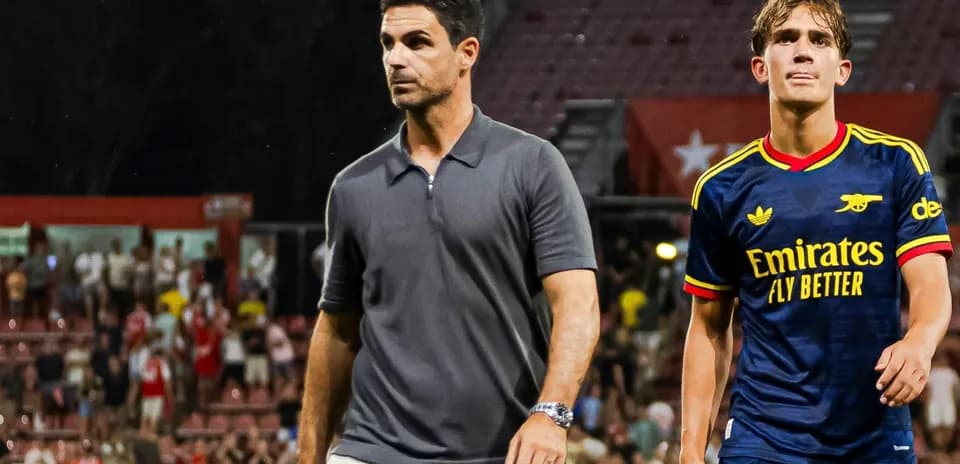 Manager and player walking off the pitch after match