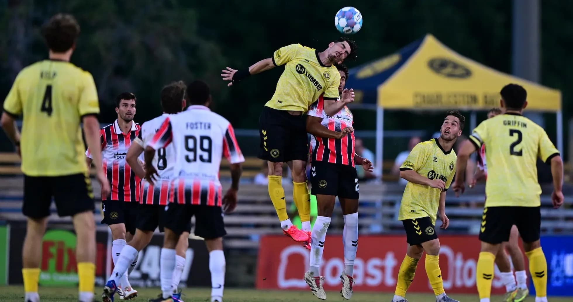 Players contesting a header during match