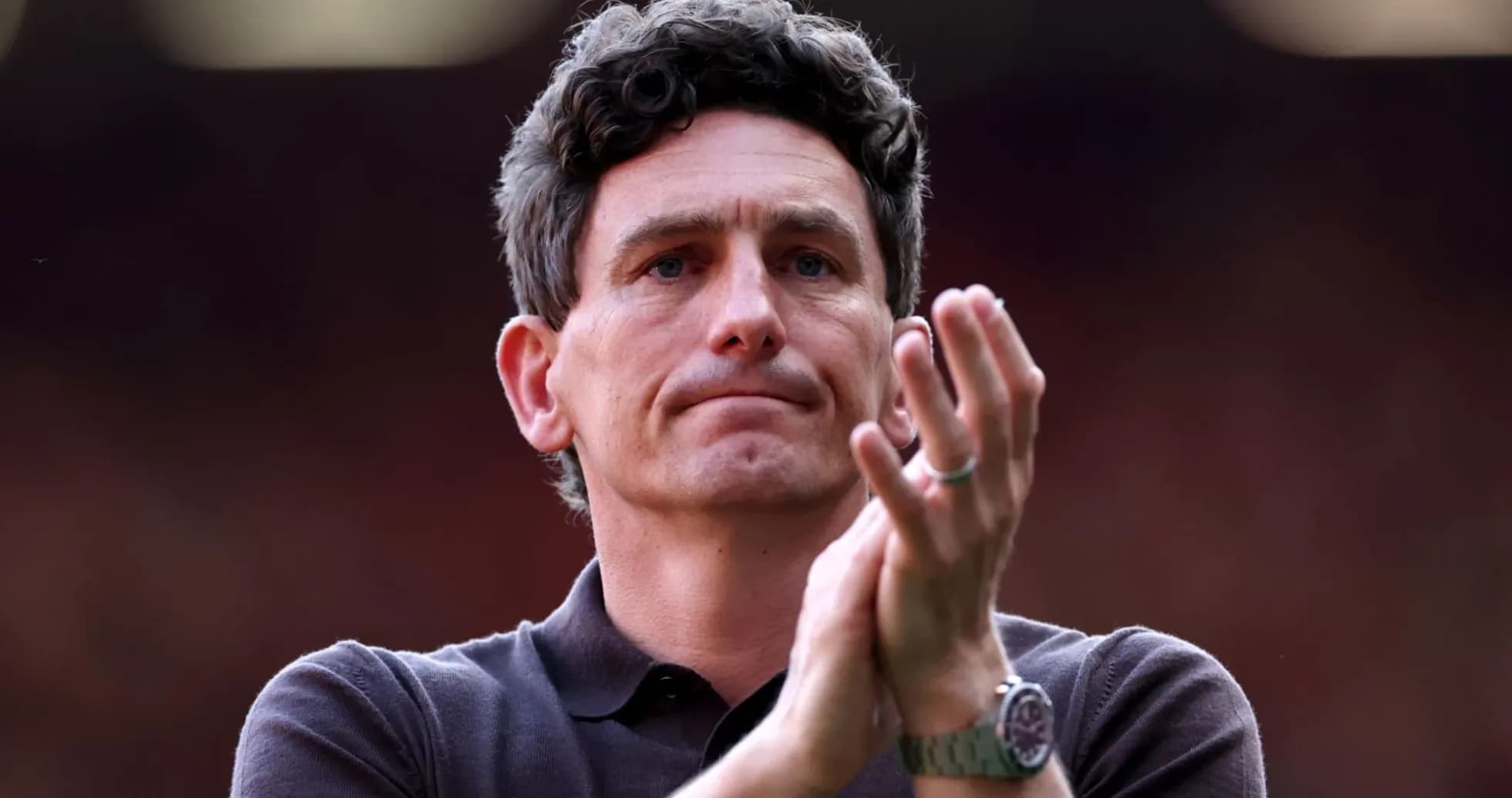 Man clapping during a football match