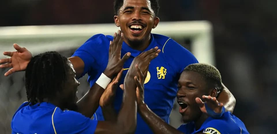 Players celebrating a goal in blue jerseys