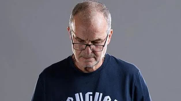 Man wearing glasses looking down thoughtfully