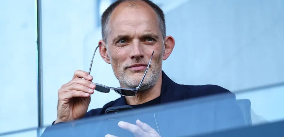 Man holding glasses, seated in viewing area