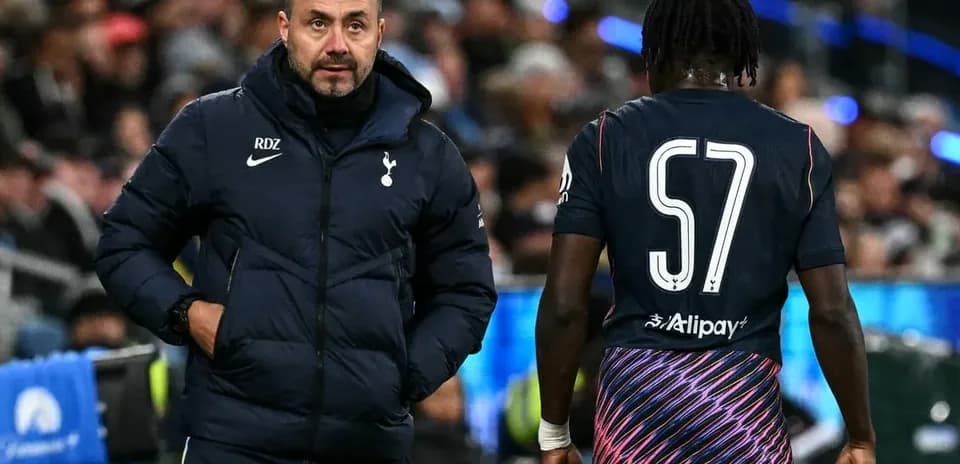 Coach speaking to player during match on sidelines