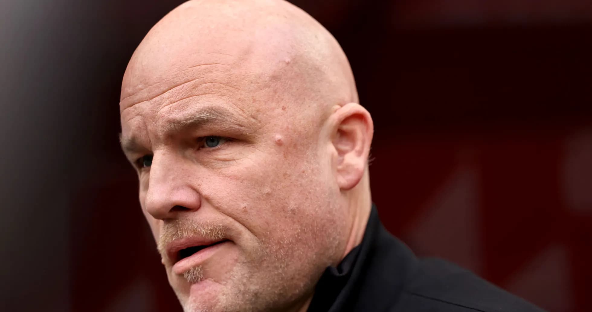 Close-up of a bald man speaking