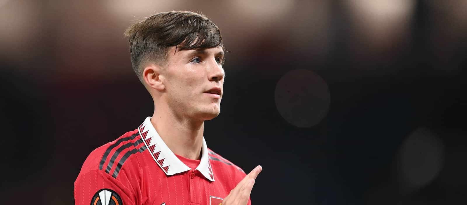 Player in red jersey gesturing during match
