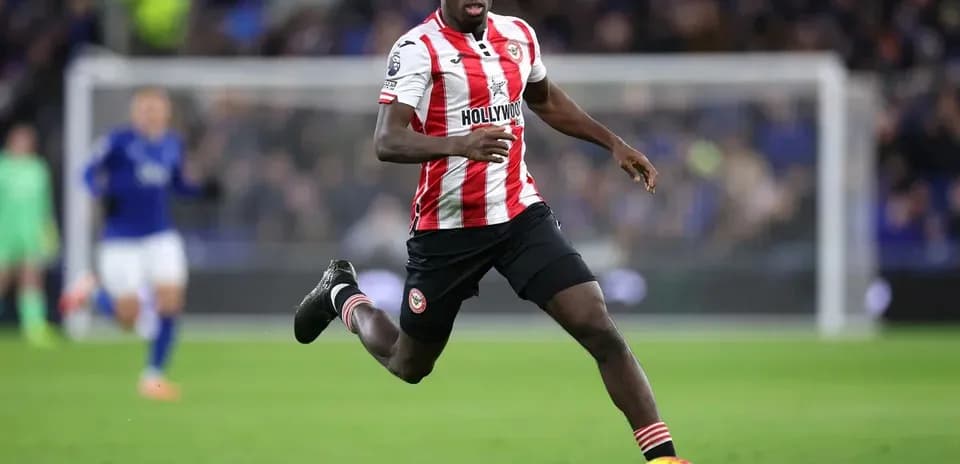 Player running with ball during match action