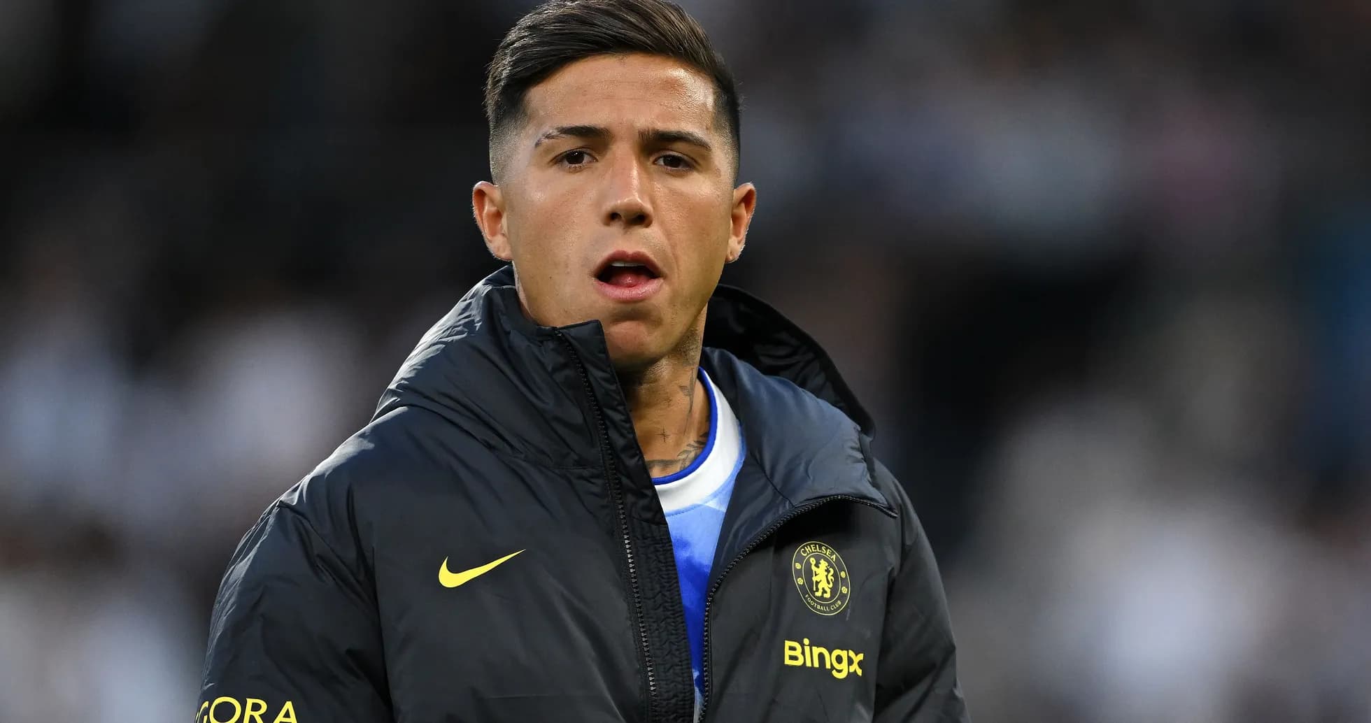 Player in Chelsea jacket during match warm-up