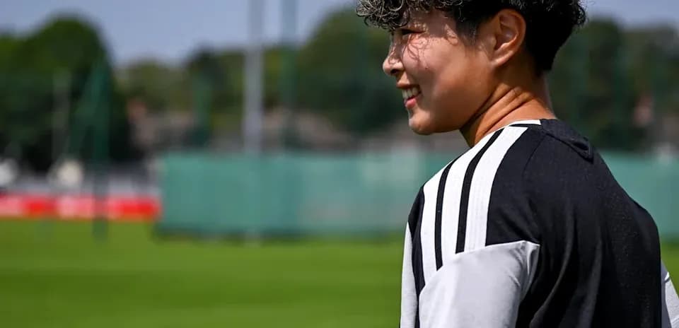 Player walking on training pitch with sunny background
