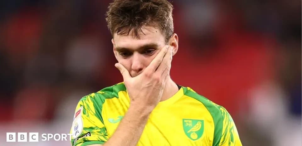 Player in yellow kit with hand on face