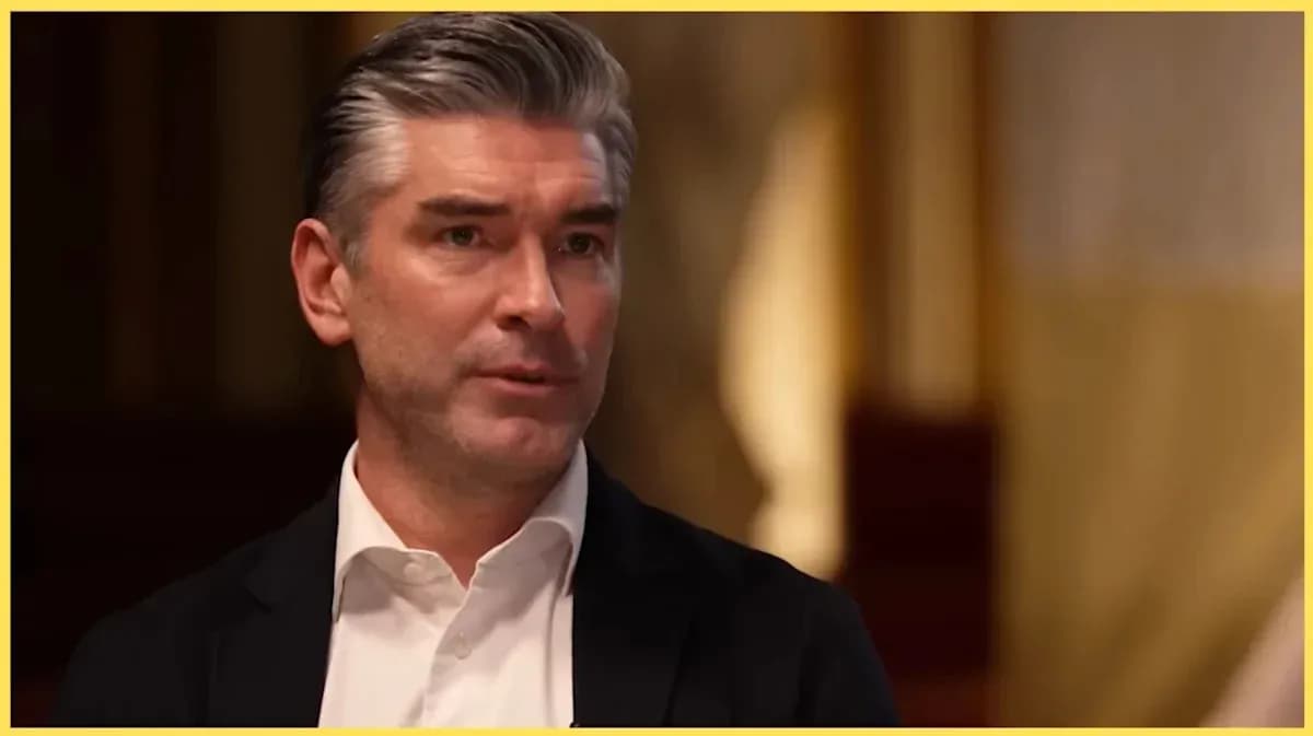 Man speaking during an interview in formal attire