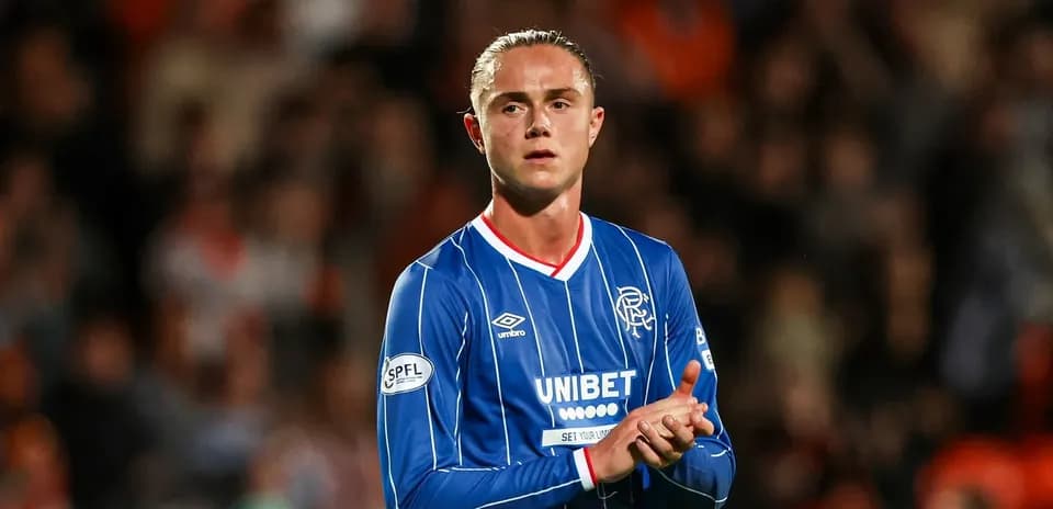 Player clapping in Rangers FC blue jersey