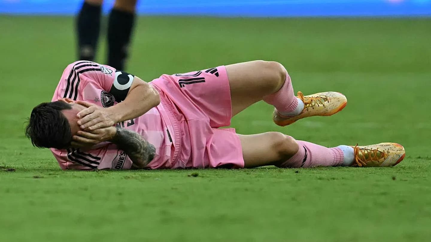 Player lying on ground holding face in pain