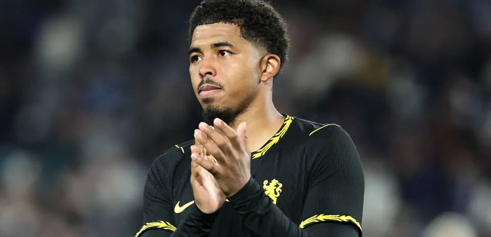 Player applauding fans after match wearing Chelsea kit