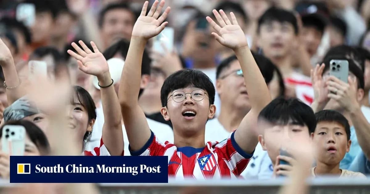 Fans cheering enthusiastically in a crowded stadium