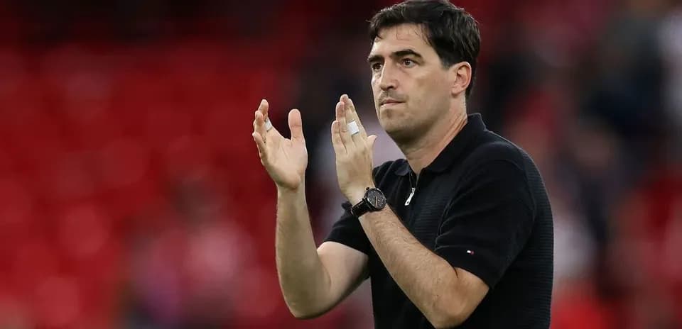 Coach gesturing and clapping during match