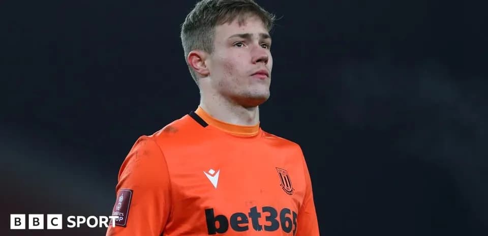 Goalkeeper in orange kit during match