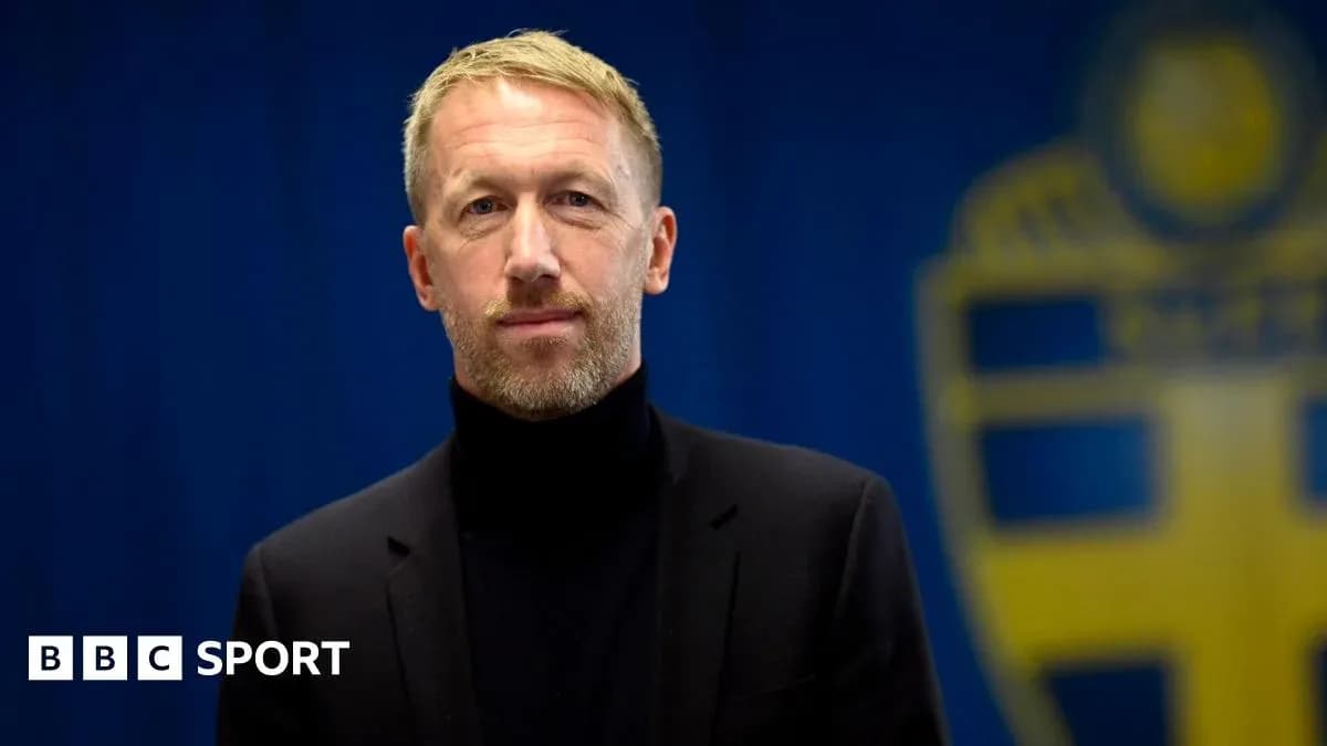 Man in black suit against blue backdrop