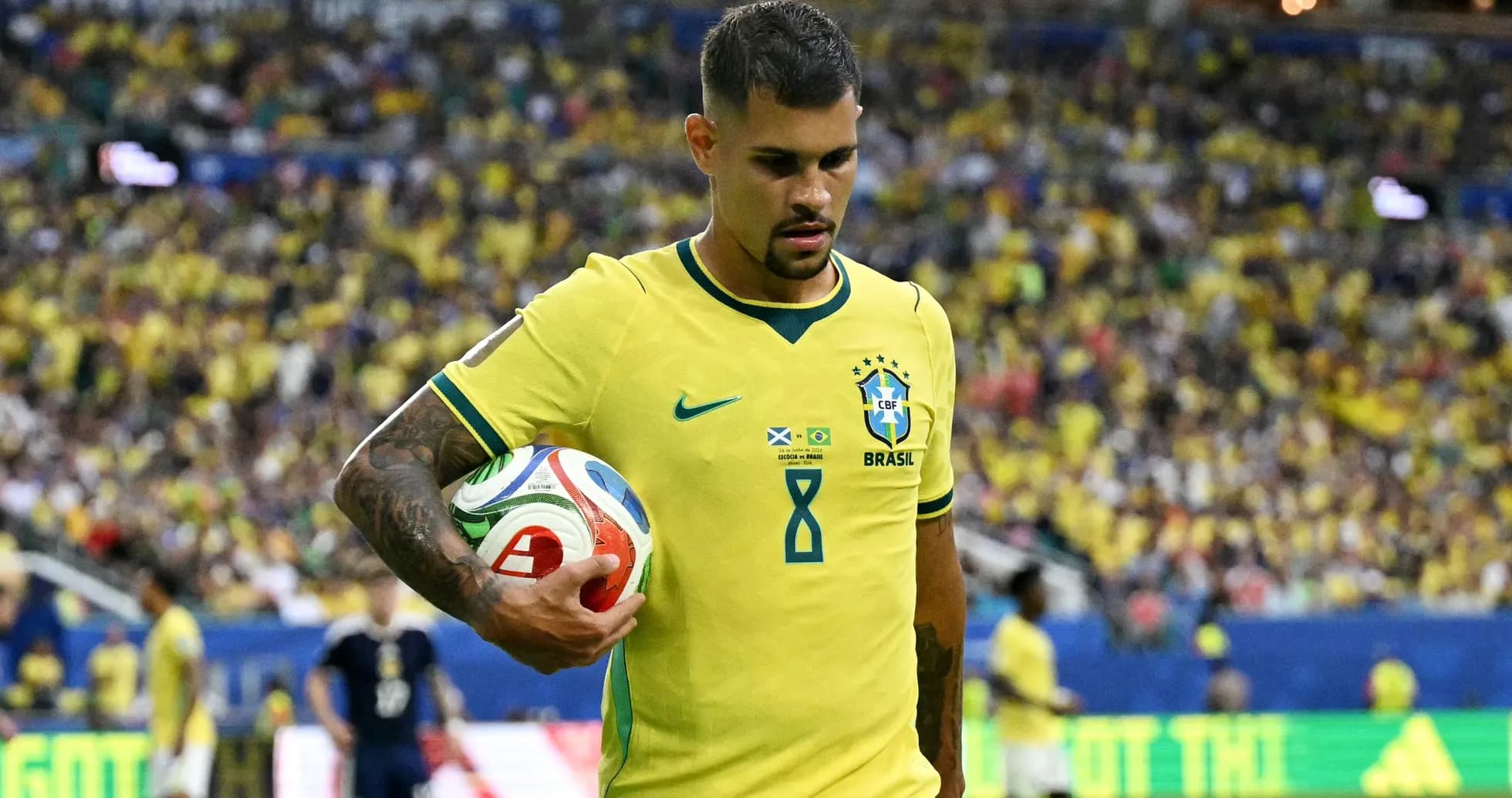 Brazilian player holding the ball on the field