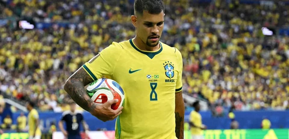 Brazilian player holding the ball on the field