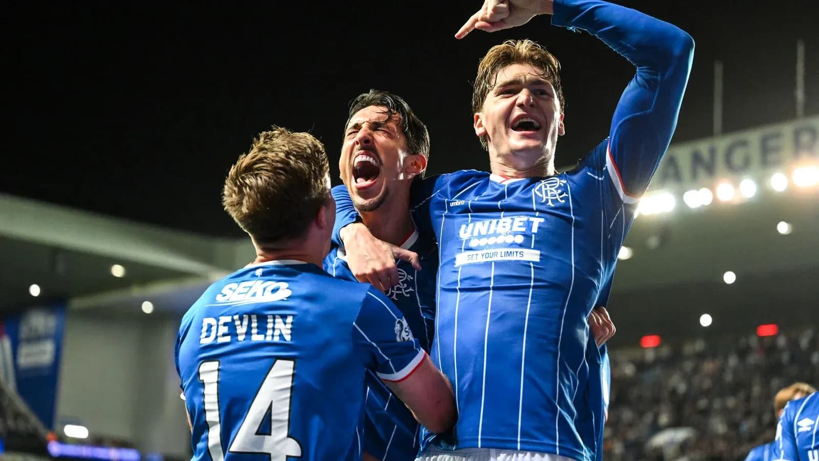 Rangers players celebrating a goal in stadium