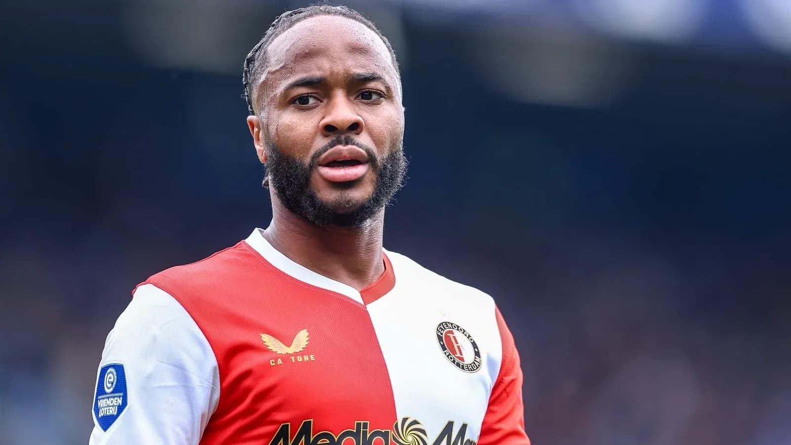 Feyenoord player in red and white kit on field