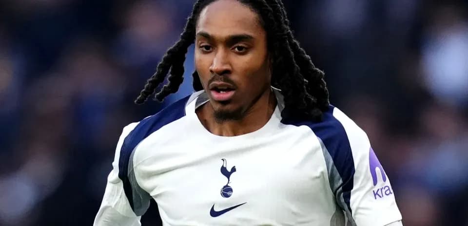 Player in Tottenham jersey running on the pitch