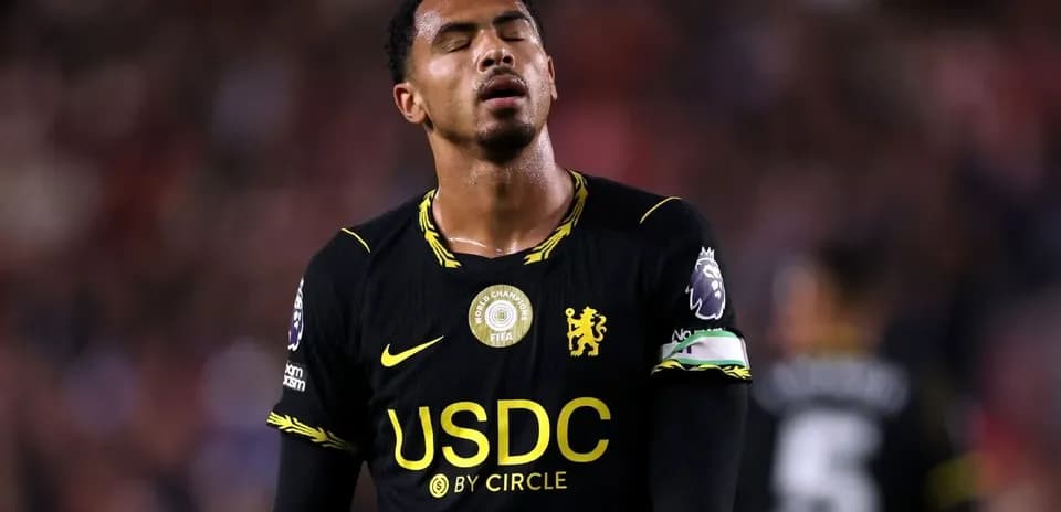 Player wearing black jersey looking down during match
