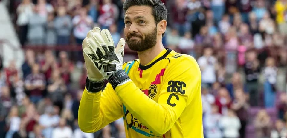 Goalkeeper in yellow jersey applauding the crowd