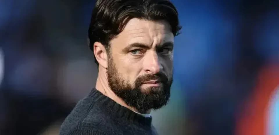 Man with beard looking intently off-camera