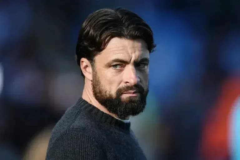 Man with beard looking intently off-camera