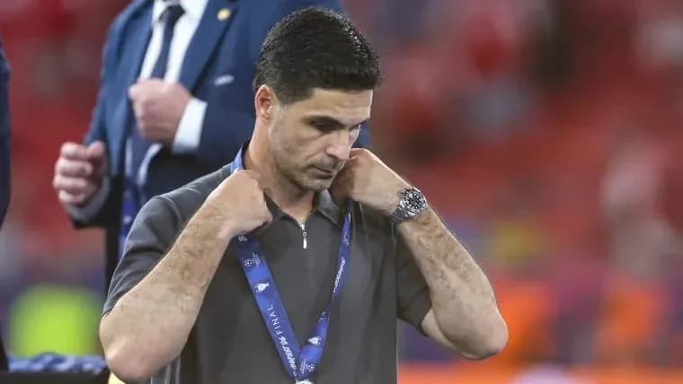 Coach adjusting his collar on the field