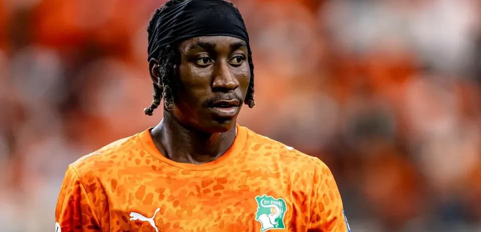 Player wearing orange jersey during match preparation