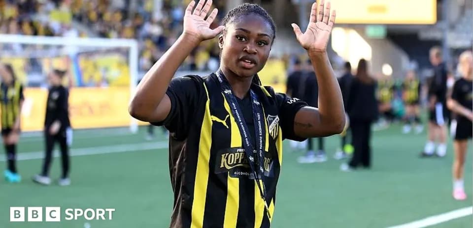 Player waving to fans on the pitch