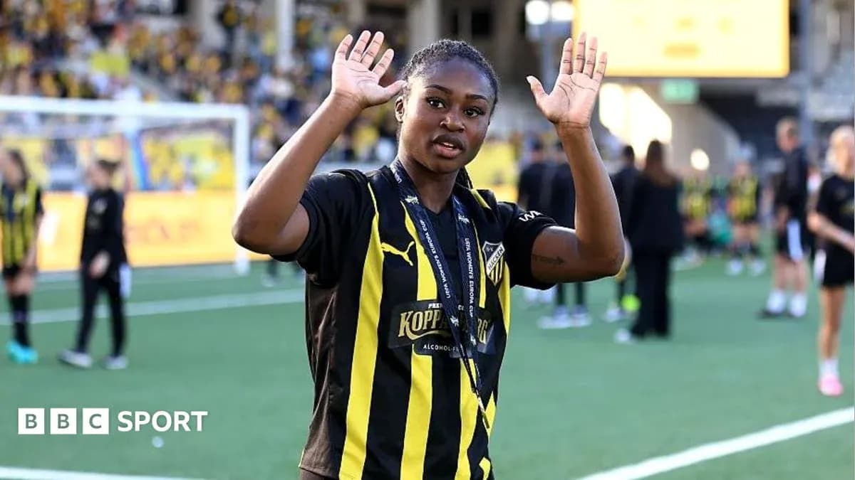 Player waving to fans on the pitch