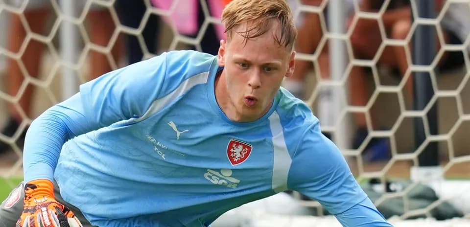 Goalkeeper diving to save a shot during training