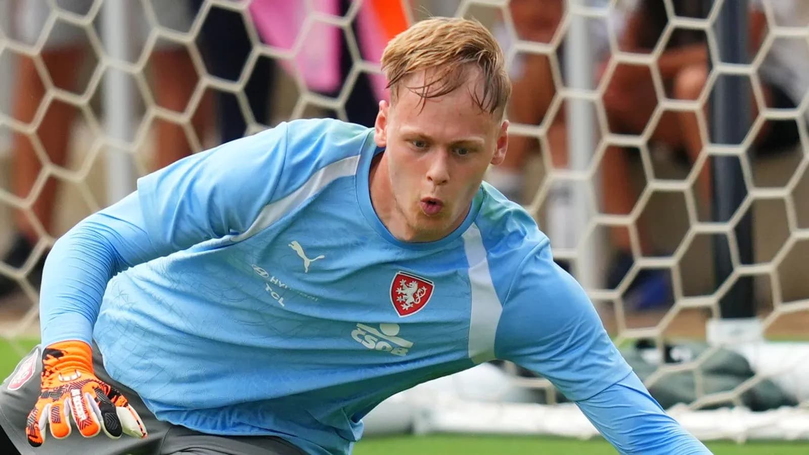 Goalkeeper diving to save a shot during training