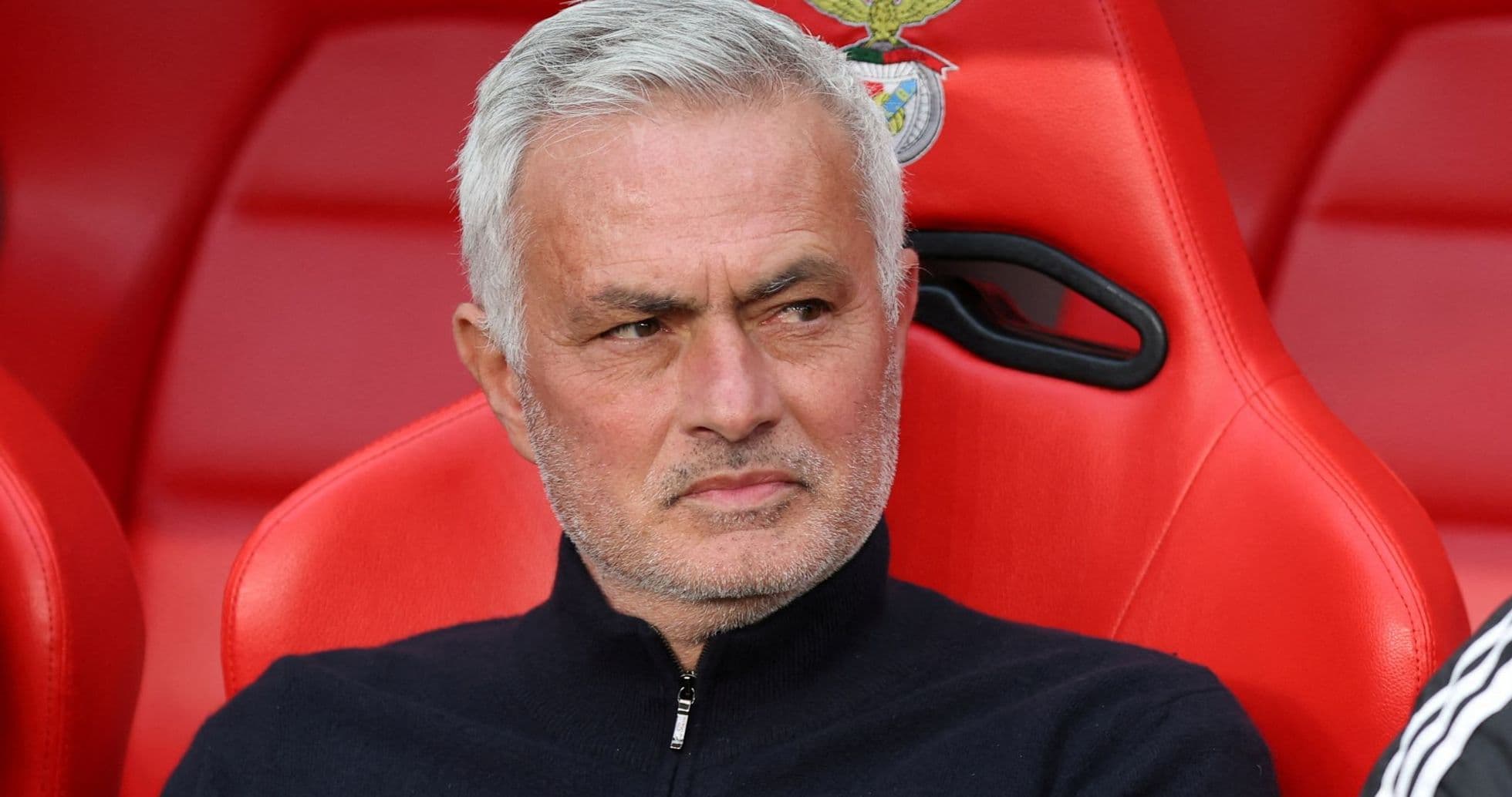 Manager seated on bench during match