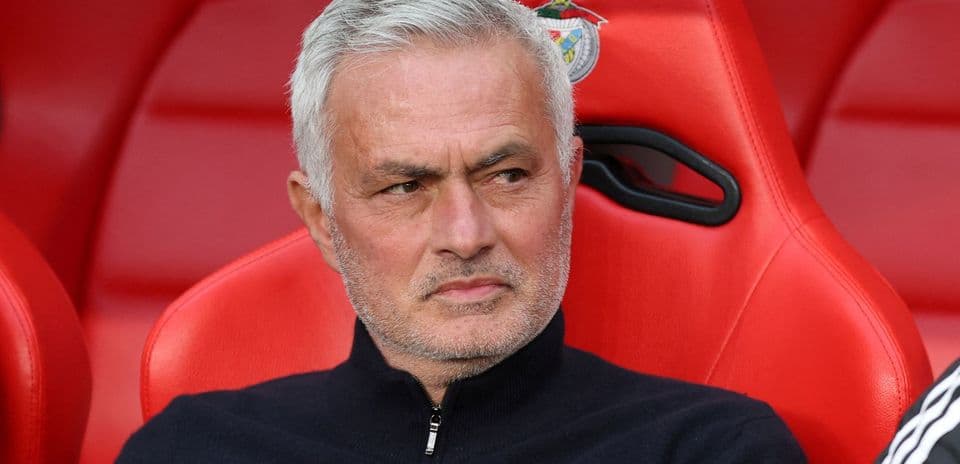 Manager seated on bench during match