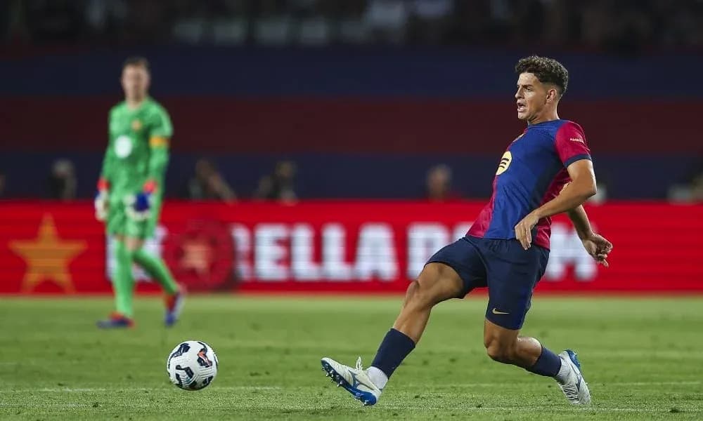Player kicking ball during match with goalkeeper in background