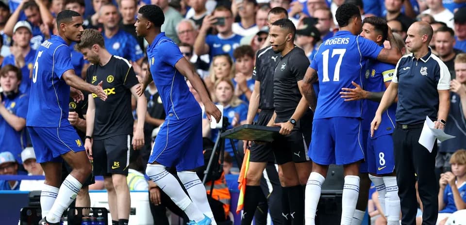 Players exchanging greetings during a substitution