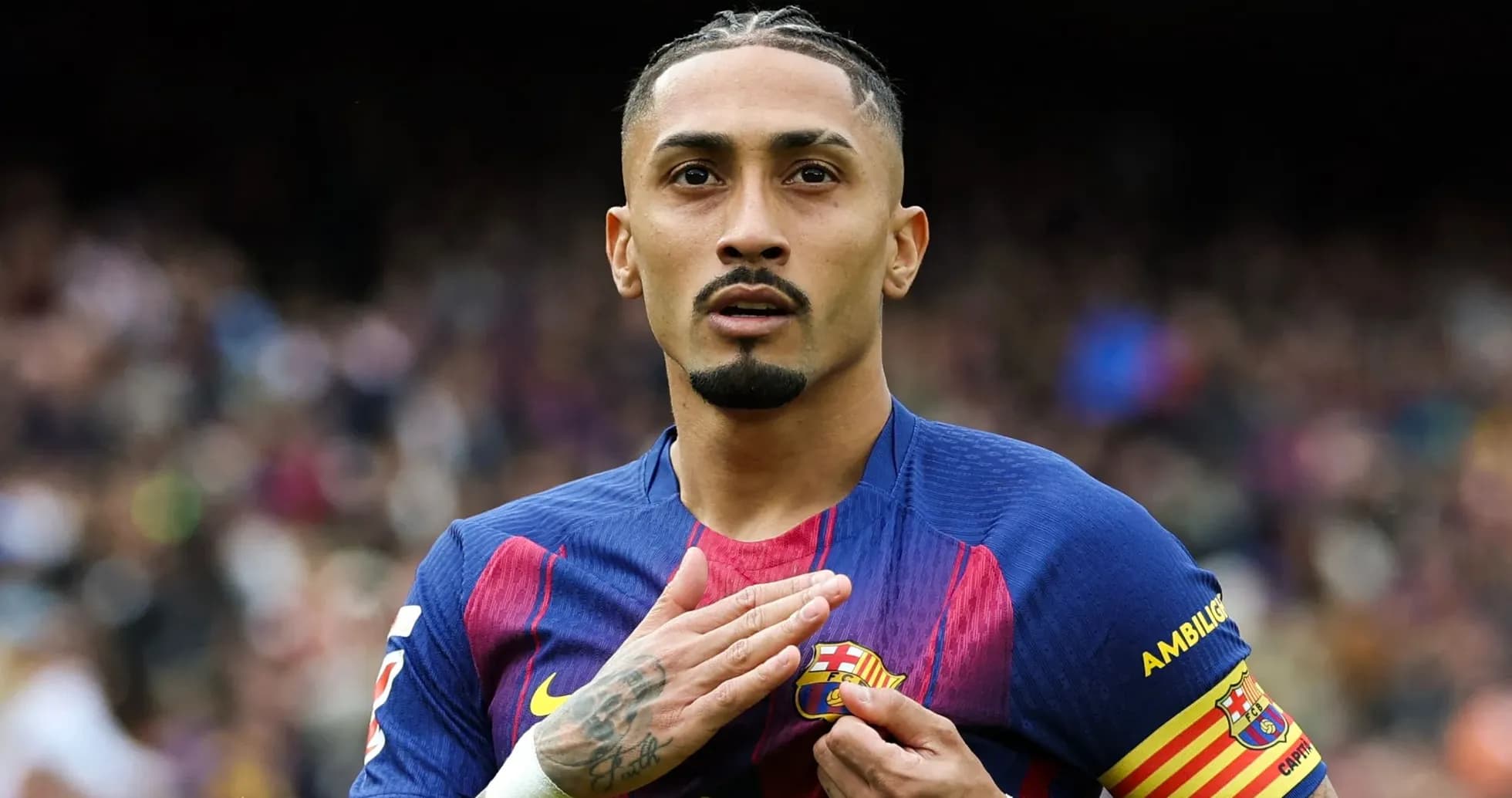 Player touching Barcelona badge during match