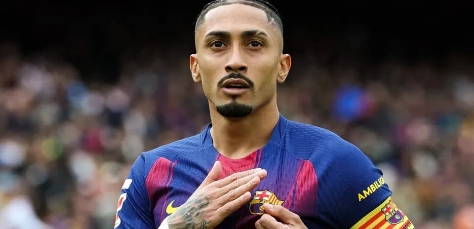 Player touching Barcelona badge during match