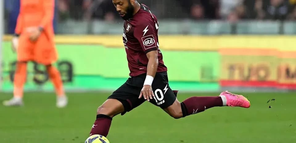 Player kicking a soccer ball during a match
